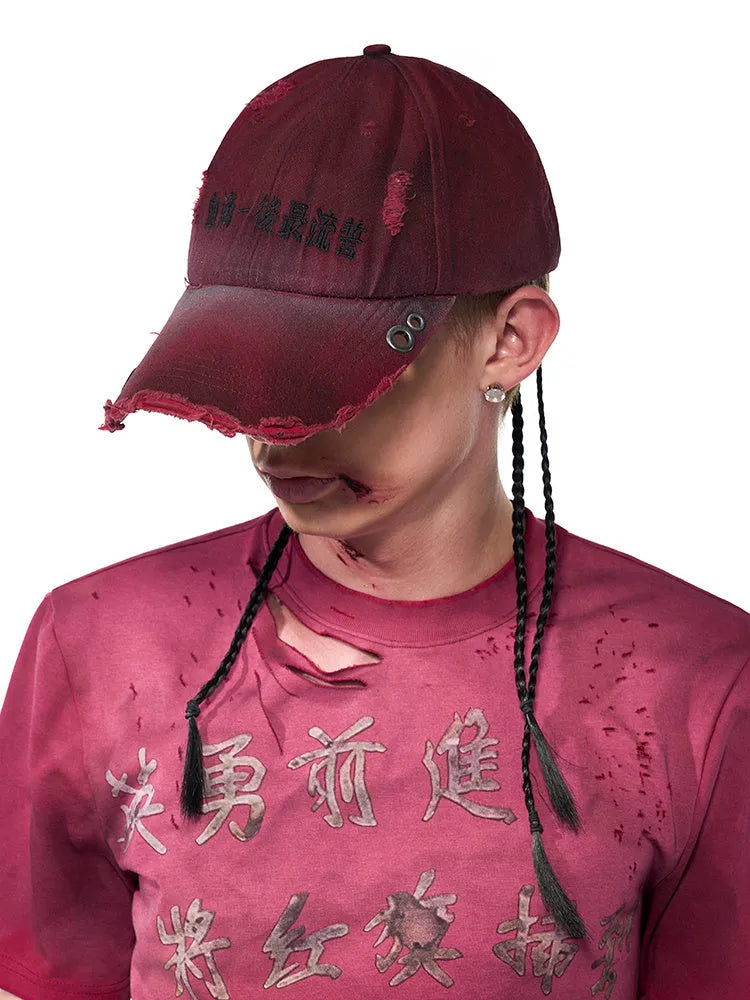 A rose red cotton peaked cap shown on a neutral background
