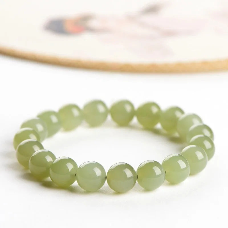Polished Hetian jade ball bracelet in a casual unisex style with spherical beads.