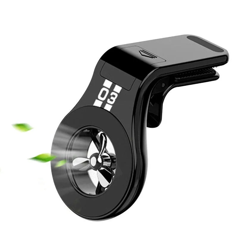 Black magnetic phone holder clipped onto a car air vent, showing phone attached and 360-degree rotation.