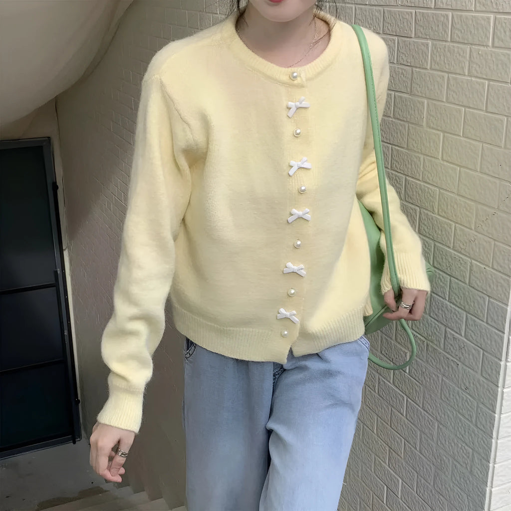 Women's acrylic cardigan with bow detail and pearl button in solid colour