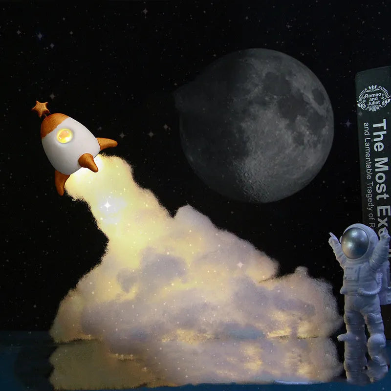 DIY astronaut rocket LED night light kit with battery and USB options, showing model parts and warm glow.