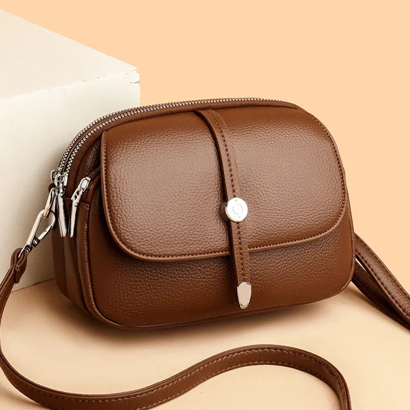 City Simple oval-shaped women's crossbody shoulder bag in khaki PU with sewing thread detail.