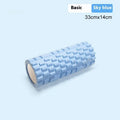 A solid black EVA foam roller on a gym floor, showing its cylindrical shape and texture.