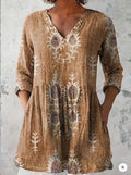 Printed women's loose wave dress with wide waist and three-quarter sleeves on a hanger.