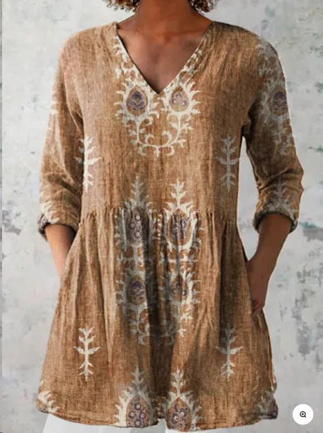 Printed women's loose wave dress with wide waist and three-quarter sleeves on a hanger.