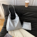 Women's large capacity soft PU shoulder bucket bag with contrast stitching in silver, front view