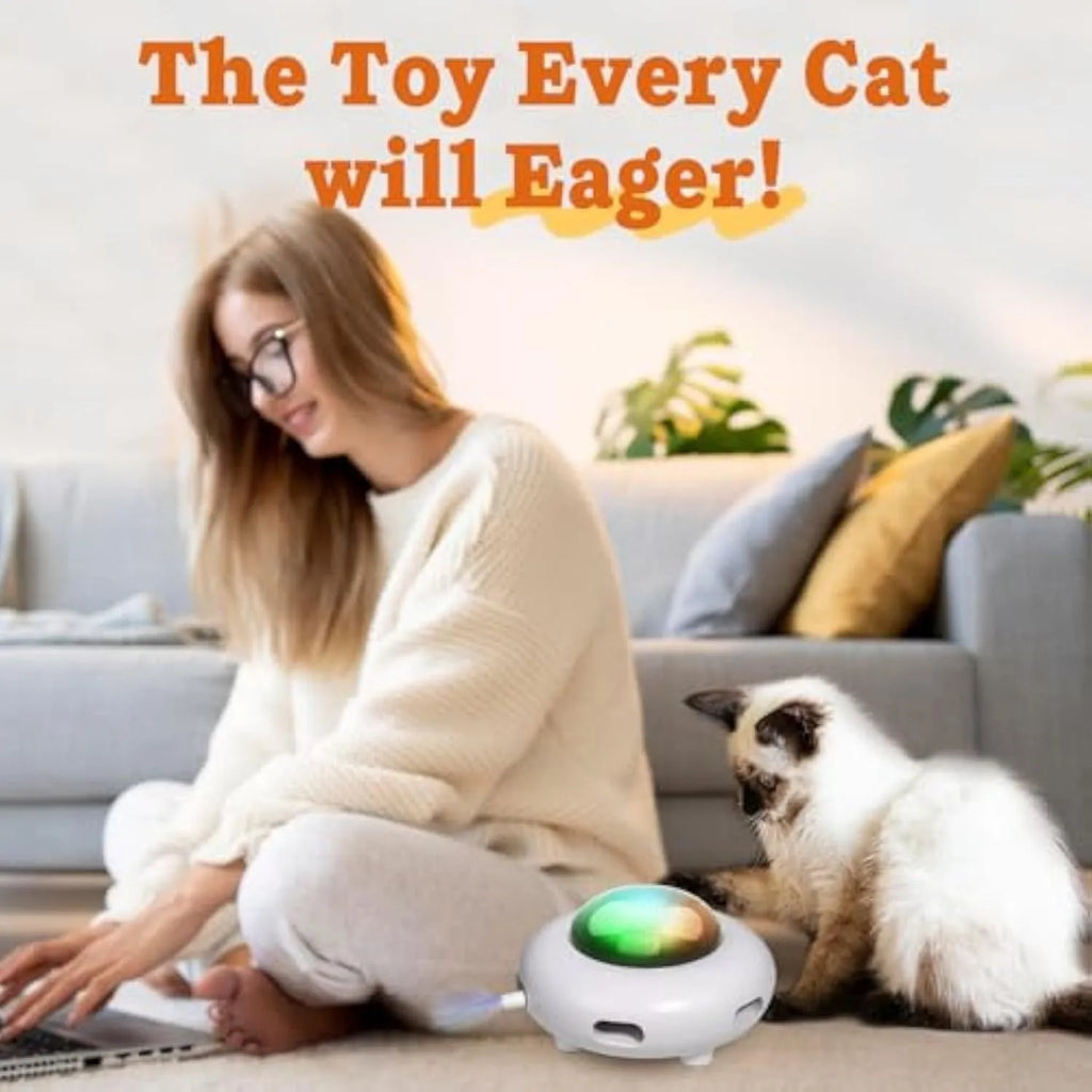White UFO-shaped interactive cat toy with colourful feathers and LED lights for indoor feline enrichment