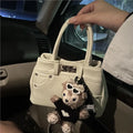 Women's denim shoulder bag in casual style with soft PU construction and polyester lining