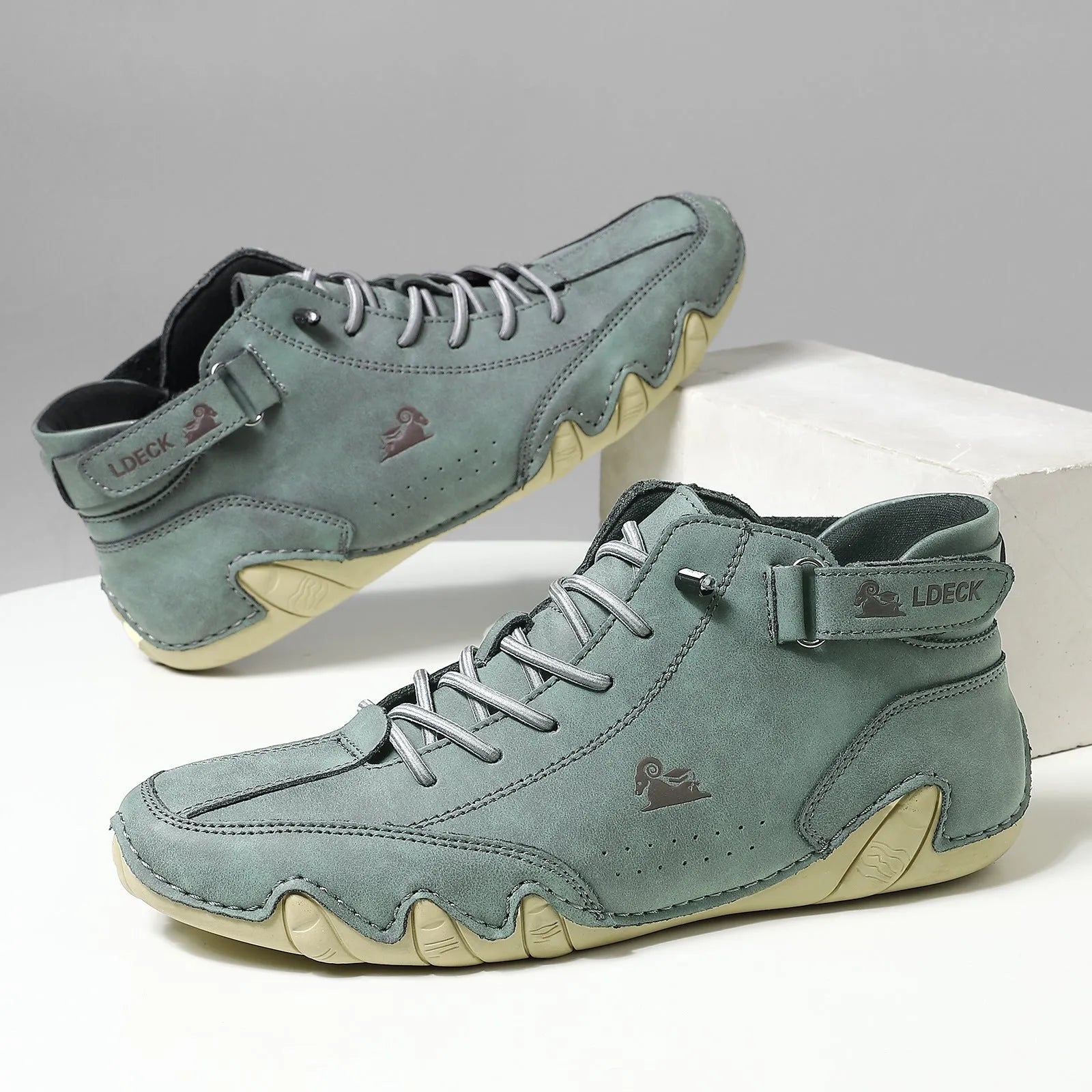 Men's khaki high top octopus boots with a rubber sole and textured microfiber upper.