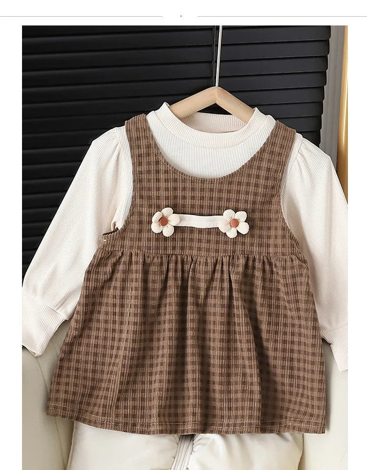 Baby girl wearing a dark coffee plaid Korean style long-sleeved dress suit set, comprising a shirt and dress.