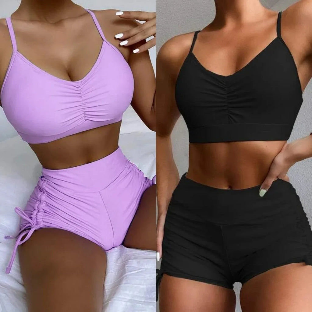 Purple and black women's high waisted bikini swimsuit with side splits.