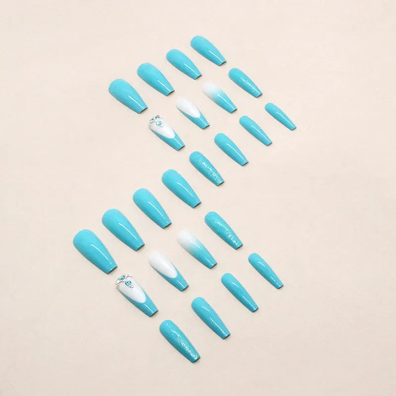 Solid colour long ballet nail art patch with smart blue diamond design on a nail, with glue bottle.