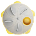 Yellow interactive pet puzzle feeder bowl with ridges and treat compartments on a white background.
