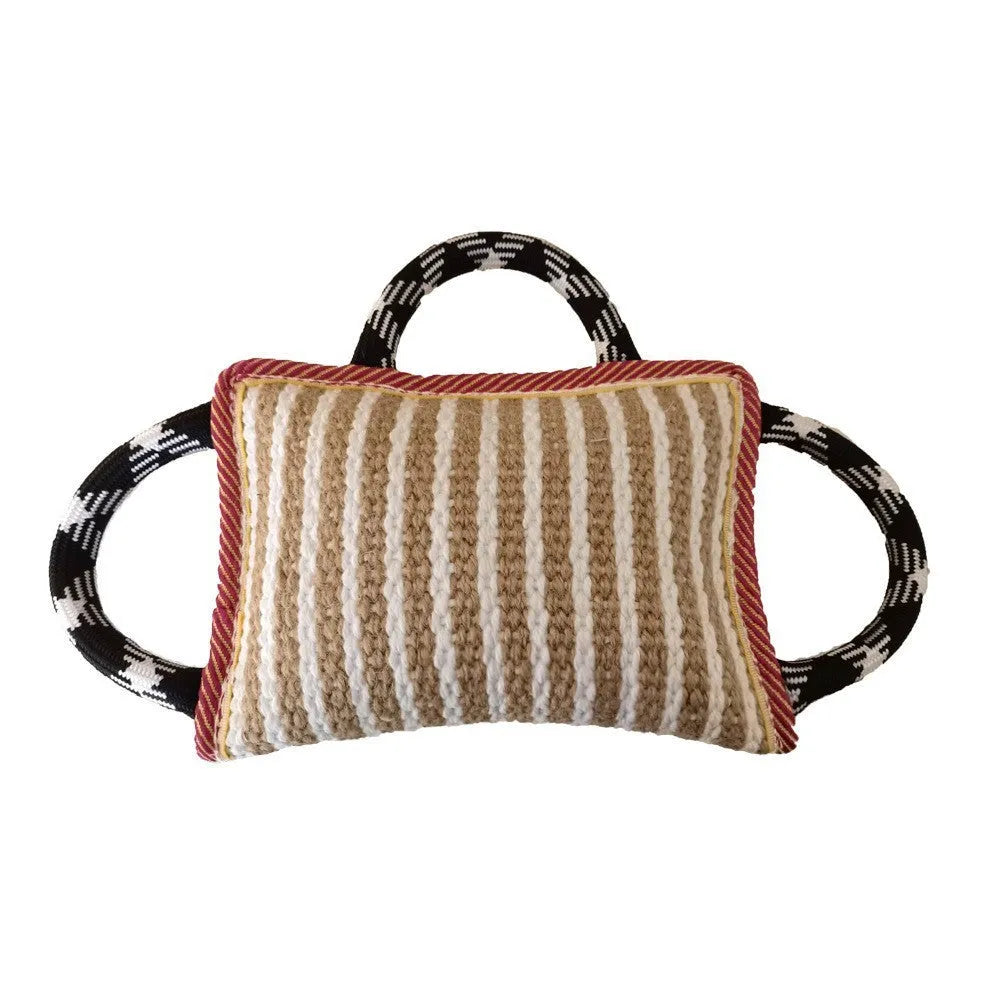 Jute dog tug toy with three rope handles in assorted colours on a neutral background.