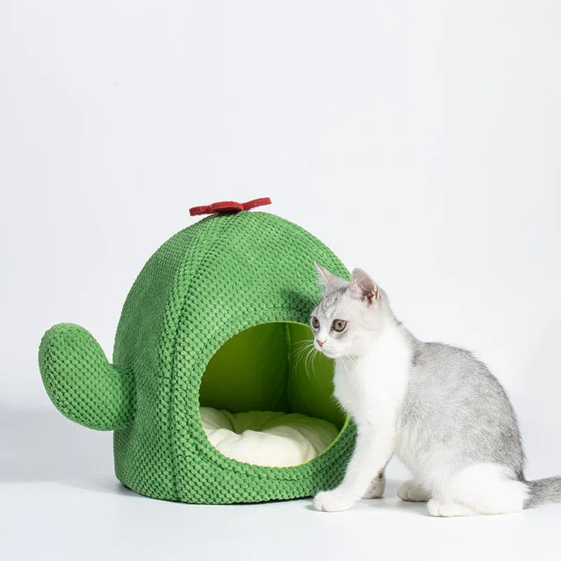 Dark green cactus-shaped enclosed cat bed with a soft interior, shown with a green accent.