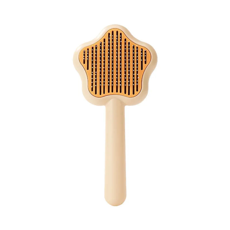 Green self-cleaning stainless steel cat comb for pet grooming on a white background