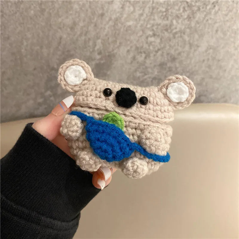 Handmade knitted koala bear backpack design cover on an AirPods case.