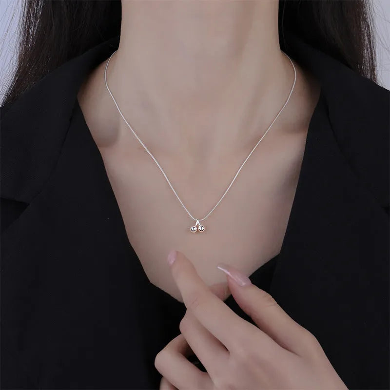 Silver cherry pendant necklace for women on an adjustable snake bones chain.