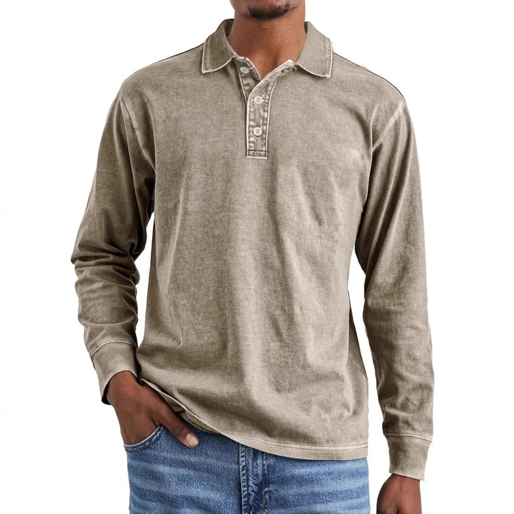 Man wearing a grey washed cotton long sleeve polo shirt with a lapel collar and subtle distressing.