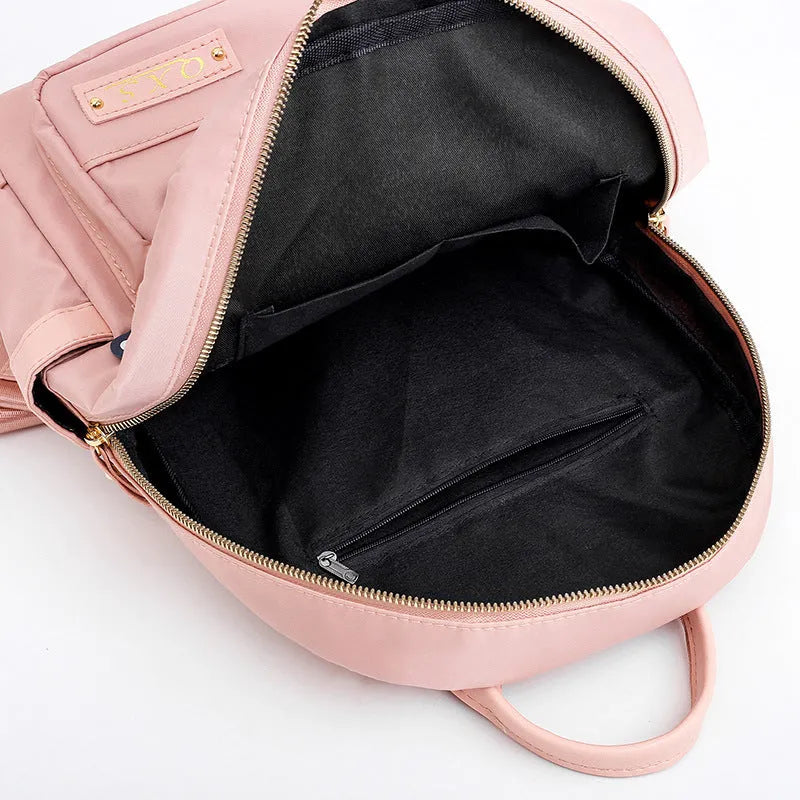 A black soft nylon women's casual travel backpack with double straps and multiple internal compartments.