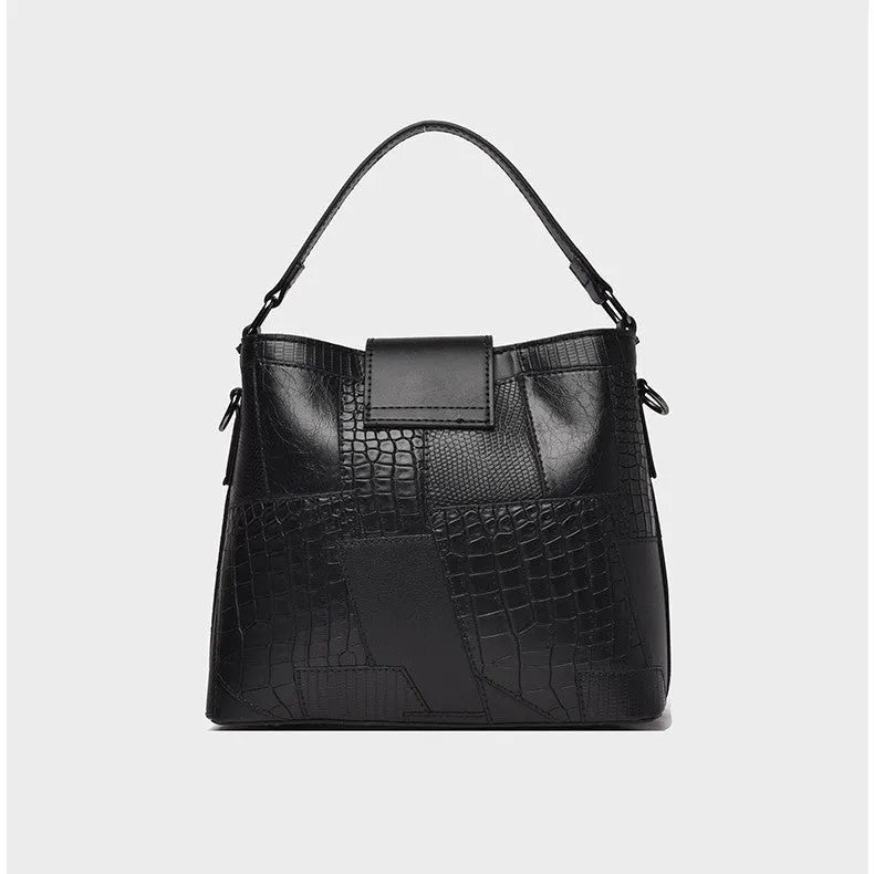 PU leather crossbody handbag with sewing line detail in brown, showing outer sandwich pocket and adjustable strap against neutral background