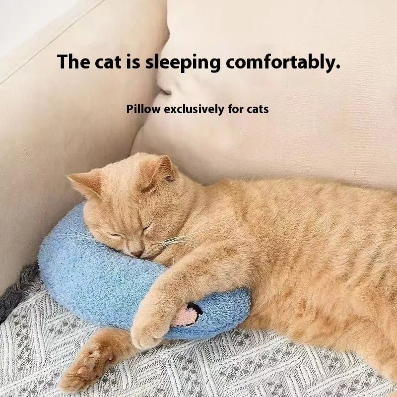 Blue U-shaped question mark cat pillow on a carpet, showing its contoured neck support design.