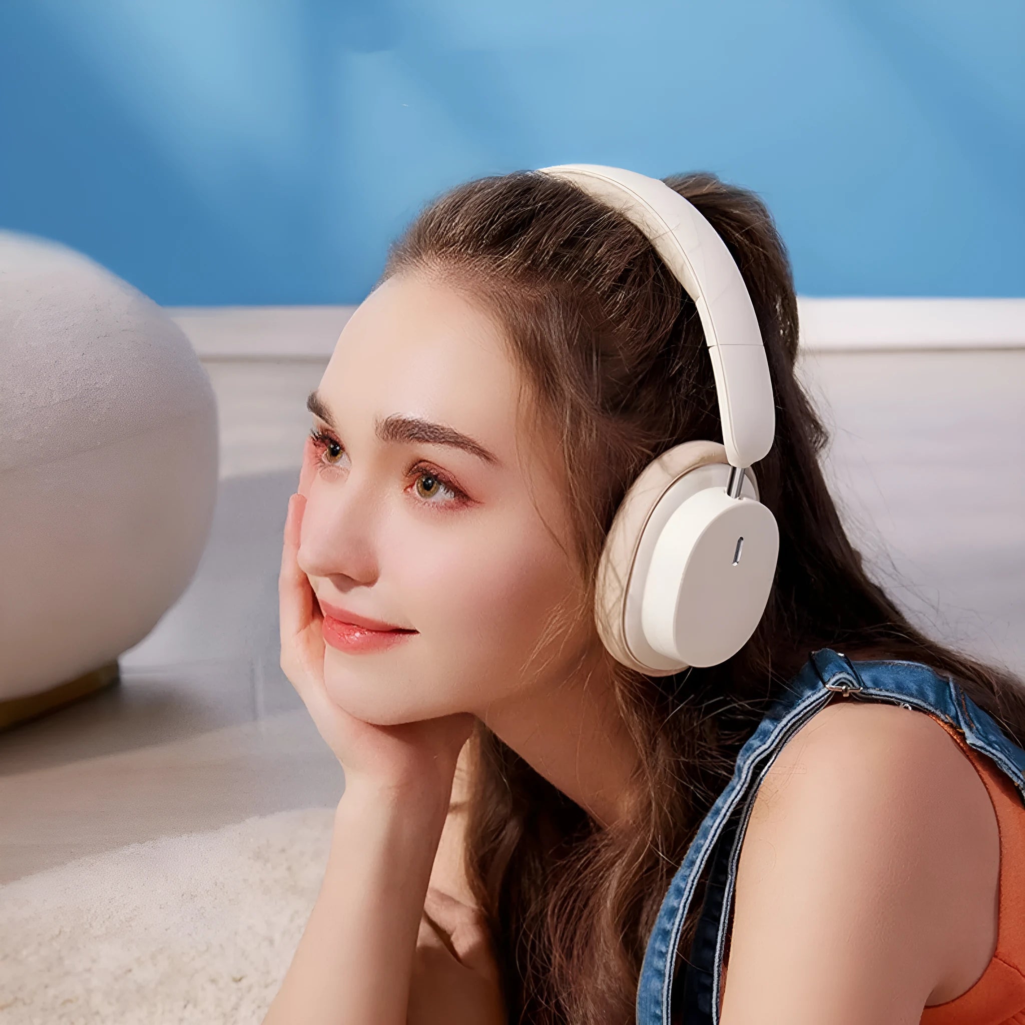 Beige wireless Bluetooth over-ear headphones with a headband, shown with a Type-C charging cable.