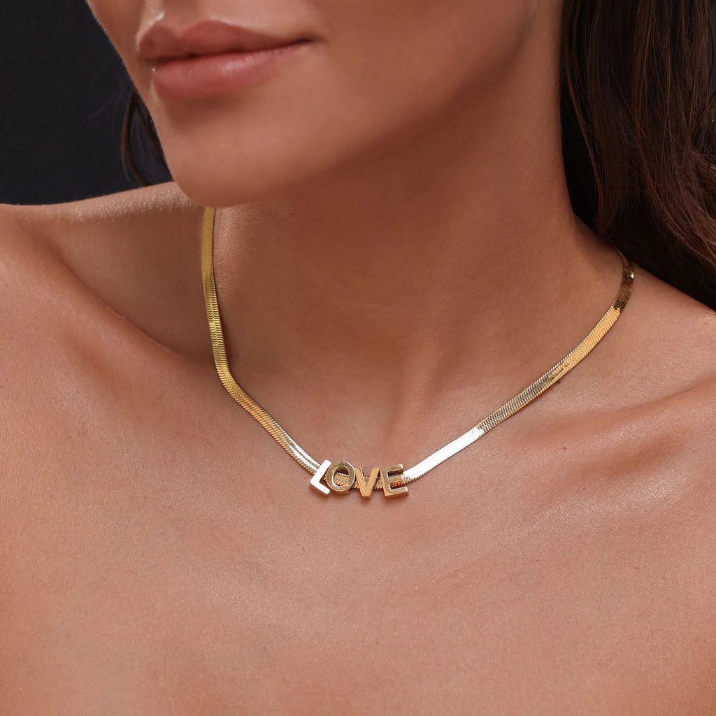 Gold electroplated titanium steel necklace with the letter 'A' pendant on a 40.5 cm chain.