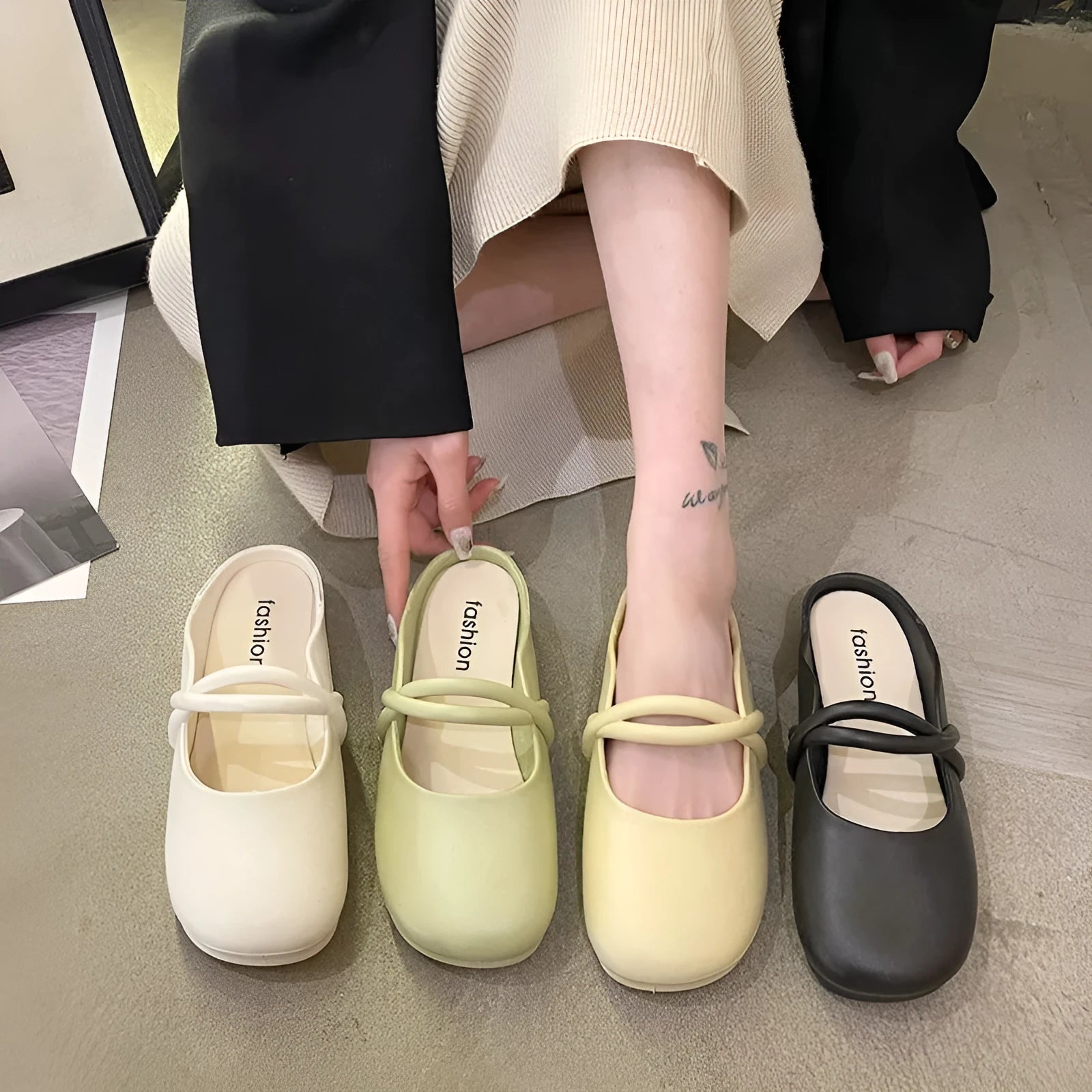 Women's black plastic flip flop sandals with enclosed Baotou front, shown on a white background.