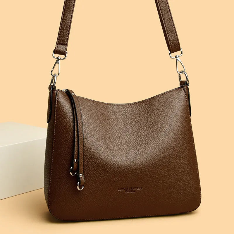 Genuine leather horizontal square shoulder crossbody bag with metal belt detail in beige colour