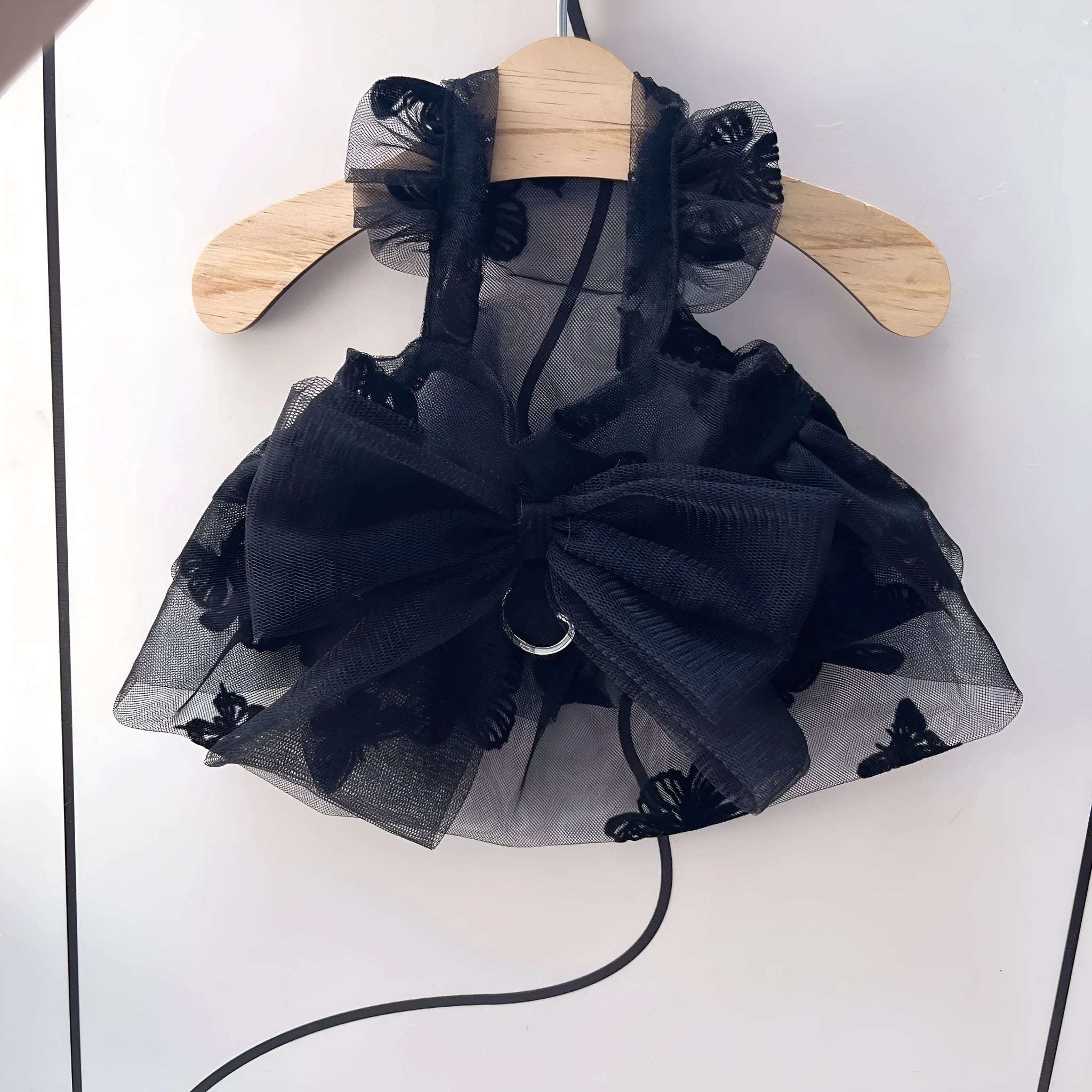 Black layered tulle princess skirt on a small dog, showing elastic waistband and tiered design.
