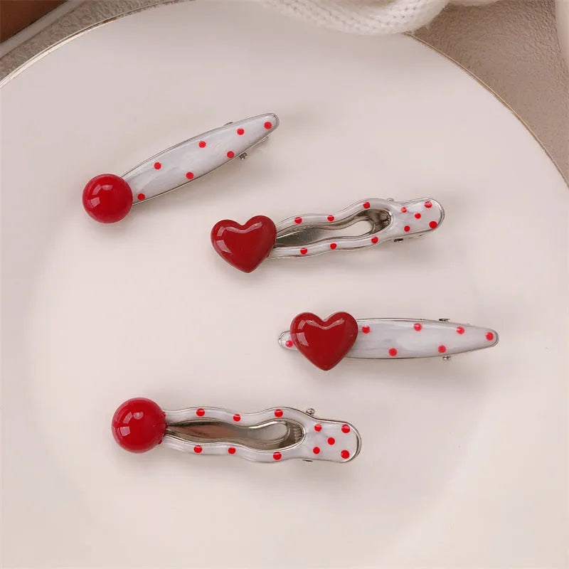 Red heart-shaped hair clip with retro dot patterns and willow leaf clip design