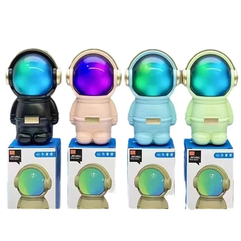 Spaceman mini stereo speaker in pink, USB powered with lighting, on a desktop