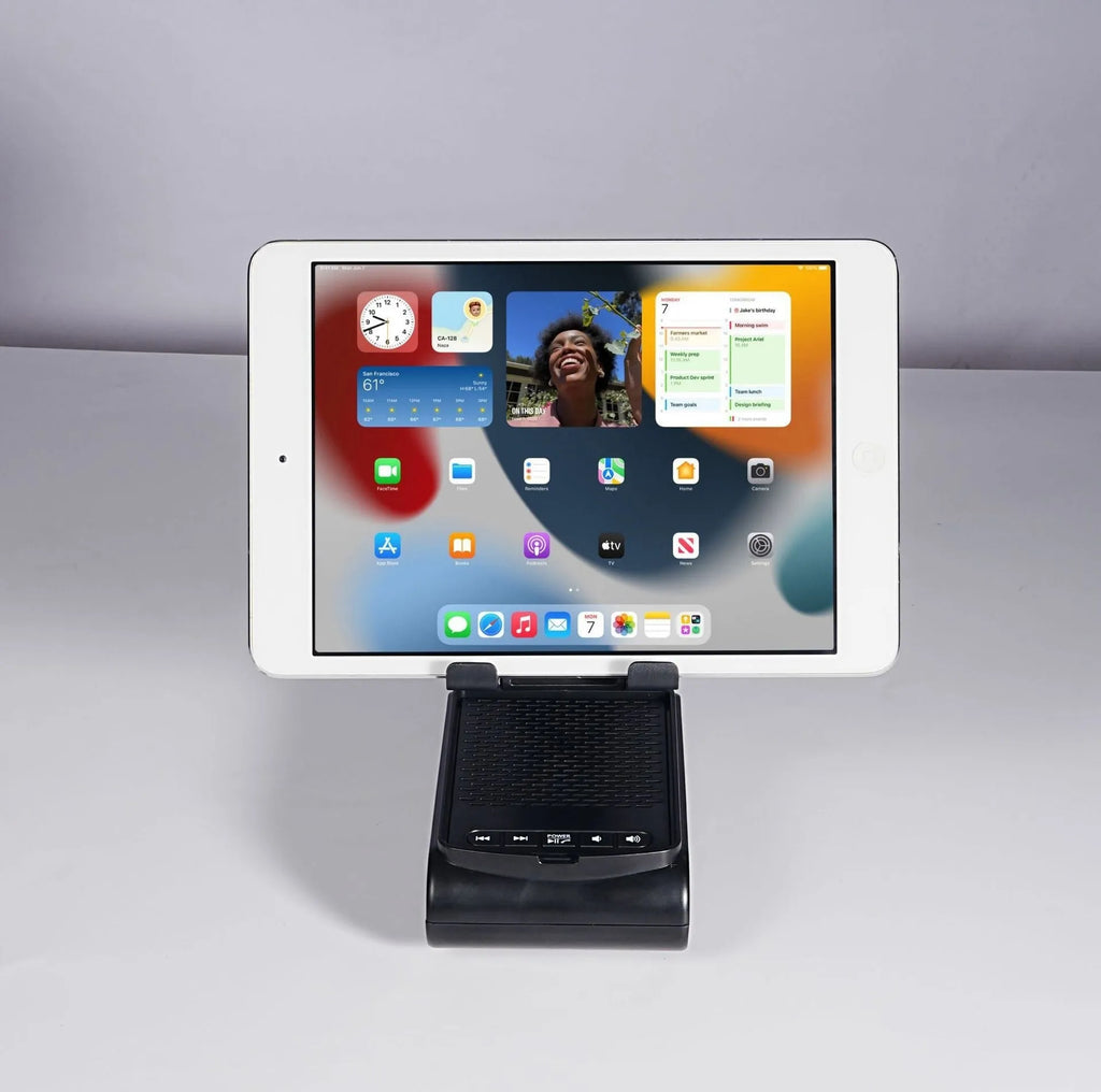 Multi-function plastic lazy phone holder with built-in Bluetooth speaker, USB powered, black colour, showing phone in stand