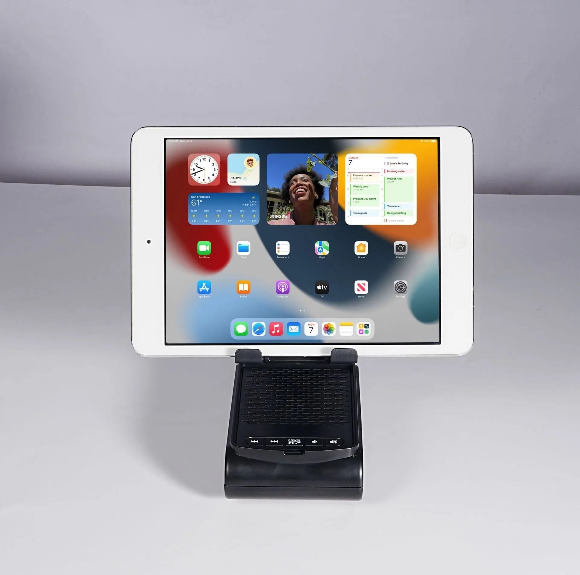 Multi-function plastic lazy phone holder with built-in Bluetooth speaker, USB powered, black colour, showing phone in stand