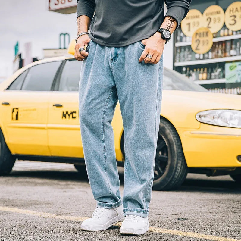Men's loose straight leg casual jeans in cotton, shown in dark blue, light blue, and grey colours.