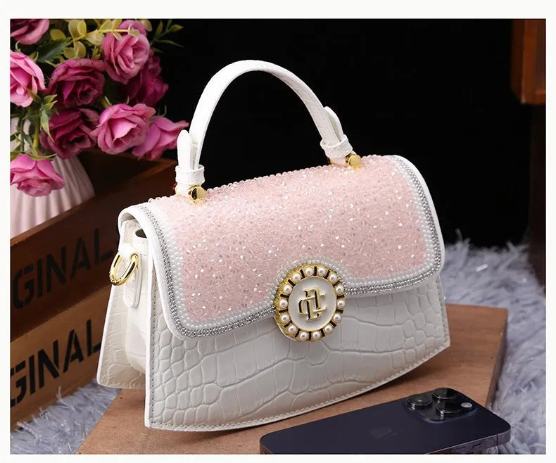 Patent leather diamond portable shoulder bag in black, brown, pink, and red with lock detail and single strap