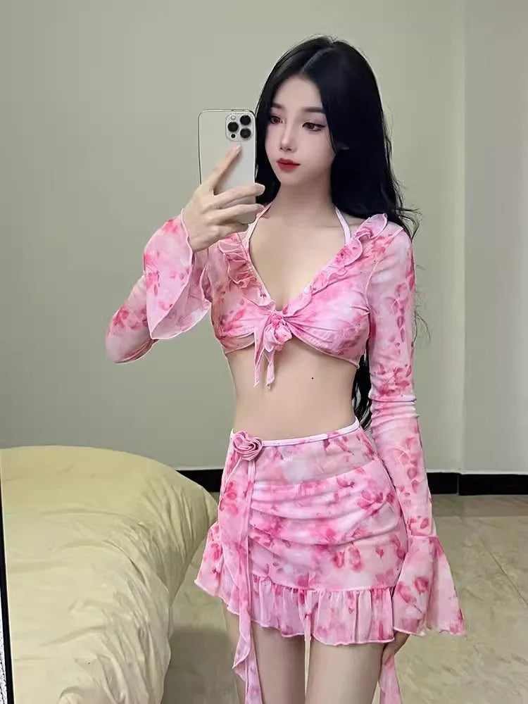 Women's cherry blossom pink floral print bikini swimsuit set laid flat.