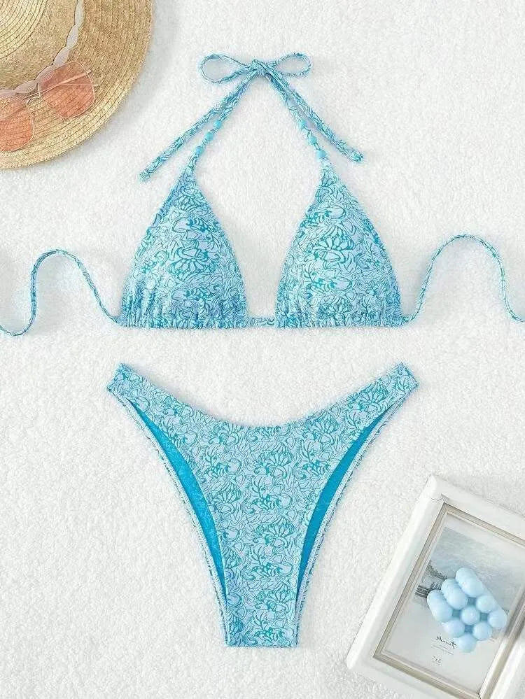 Women's floral bikini halter set with sleeveless top and shorts in polyester fabric.