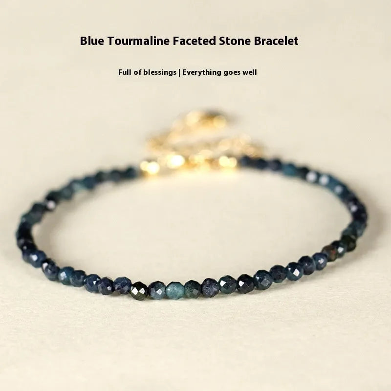 Blue tourmaline bracelet with 3mm beads and silver spacer beads on wrist