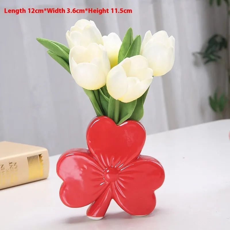 Clover white porcelain ceramic vase in European style on a desk.