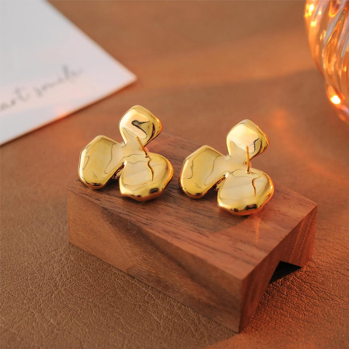 Purple copper alloy flower-shaped women's earrings with dripping oil finish on a plain background