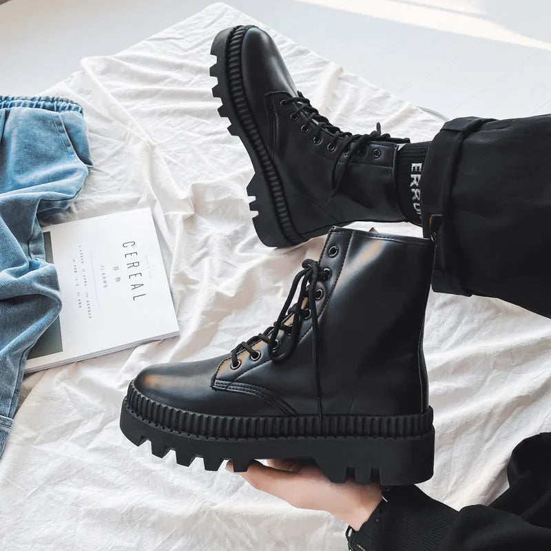 Men's black platform Dr Martens ankle boots with a zipper, showing the frosted leather and rubber sole.