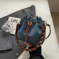 Blue synthetic leather cross-body bucket bag with adjustable strap and outer pocket