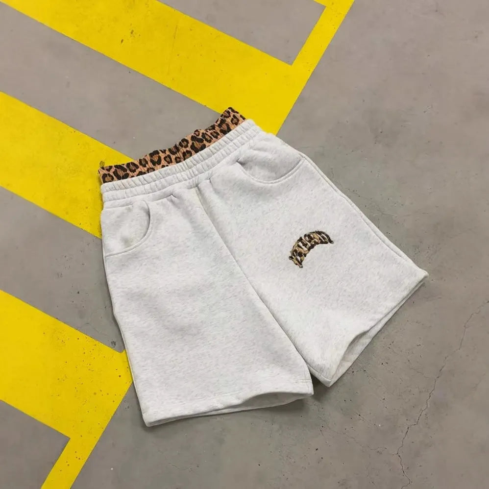 Men's grey loose trousers with a patchwork double waist design and zip fly