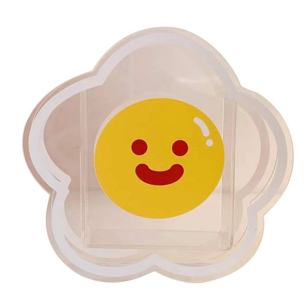 Clear square acrylic storage box with a cute illustrated strawberry rabbit design on a desk with pens.