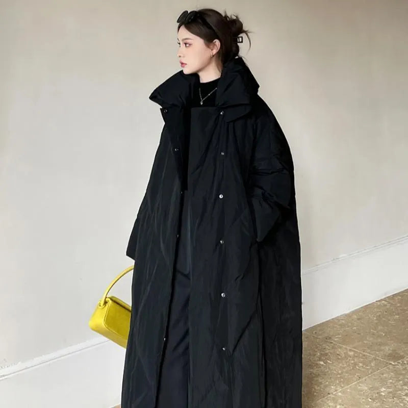 Women's large size mid-length loose fit winter coat with front zipper in black on a model