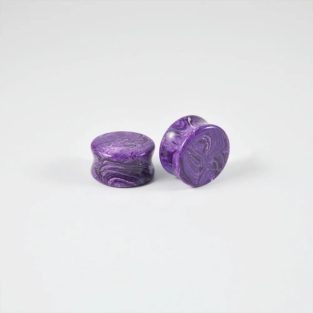 Crystal red flower stone solid expansion earplug on grey background, 6mm to 30mm sizes available, unisex geometric design