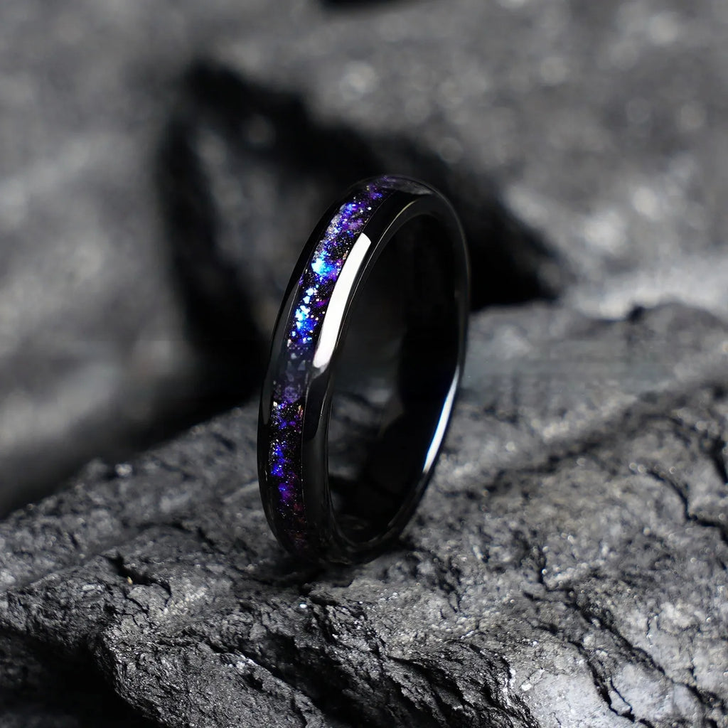 Galaxy tungsten ring with electroplated black finish and coloured inlay on a plain background