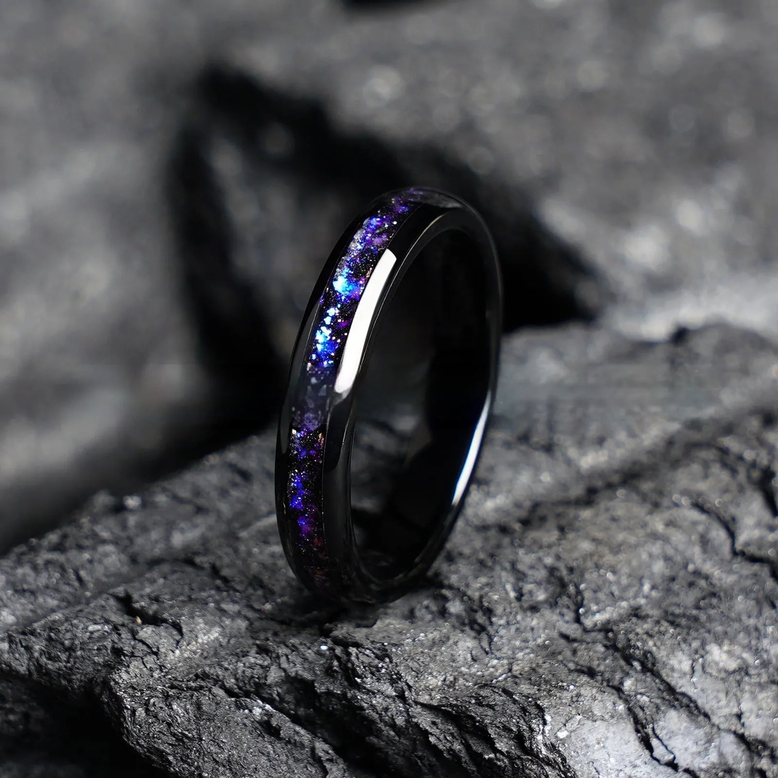 Galaxy tungsten ring with electroplated black finish and coloured inlay on a plain background